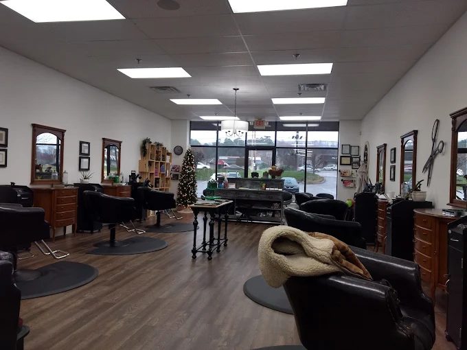Inside This Little Scissor: antique wood mirror stations, leather chairs, and wood floors in a bright room